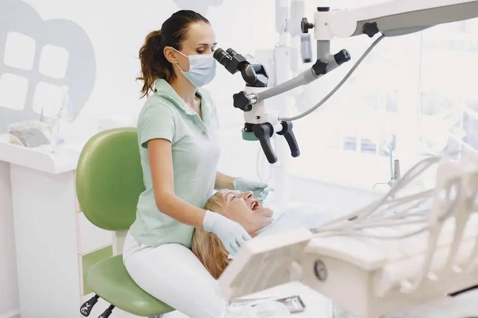 Dentist performing an examination using a microscope in a bright dental clinic.