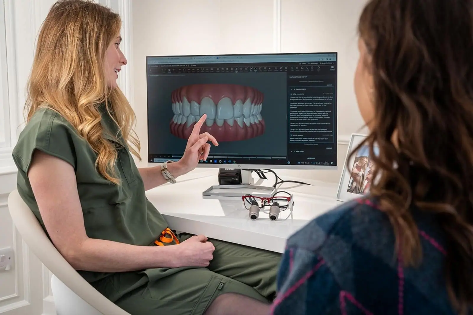 Cosmetic dentist reviewing a 3D dental model with a patient during a veneers consultation in Miami.