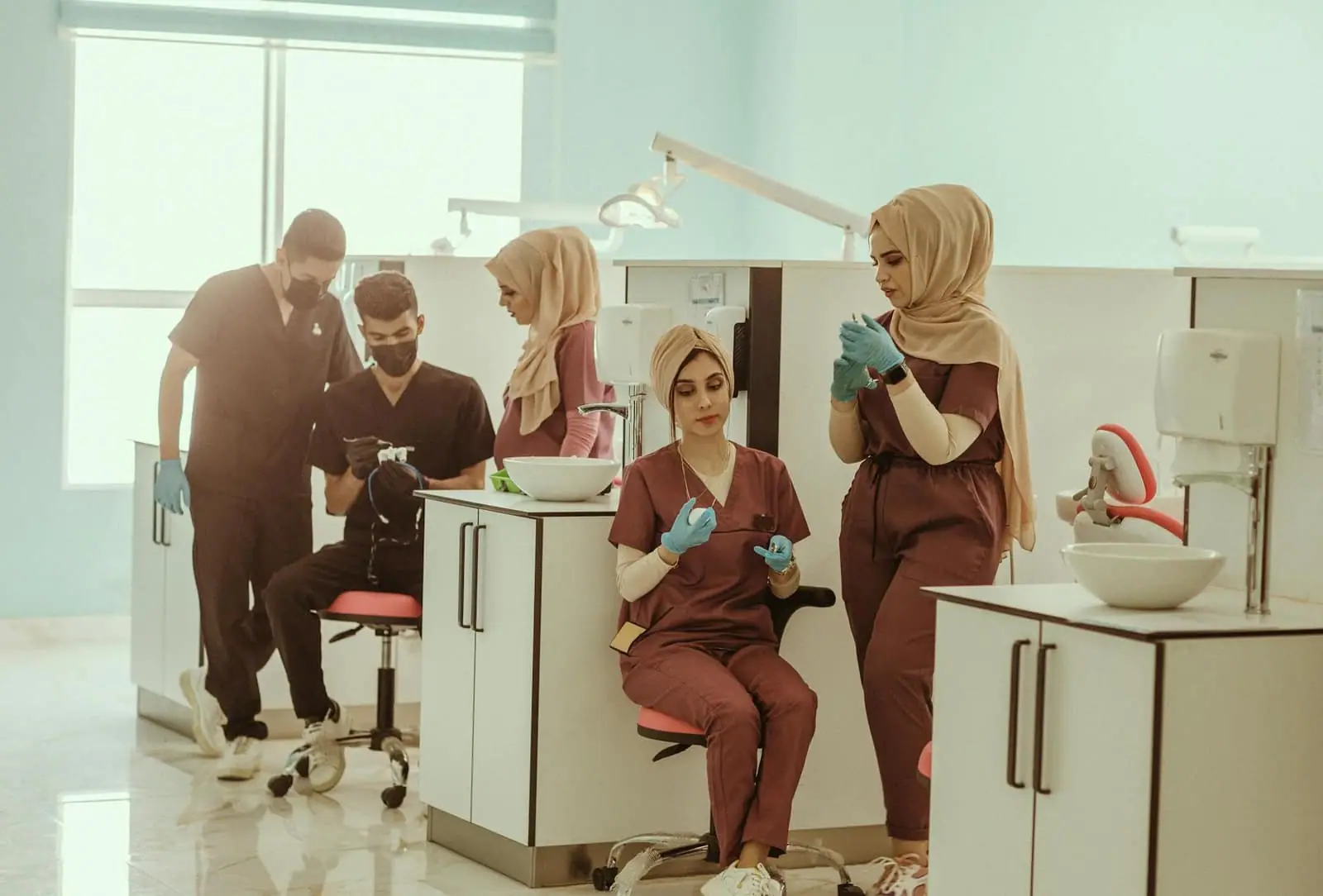 Group of diverse medical professionals in a clinic, focused on healthcare tasks.
