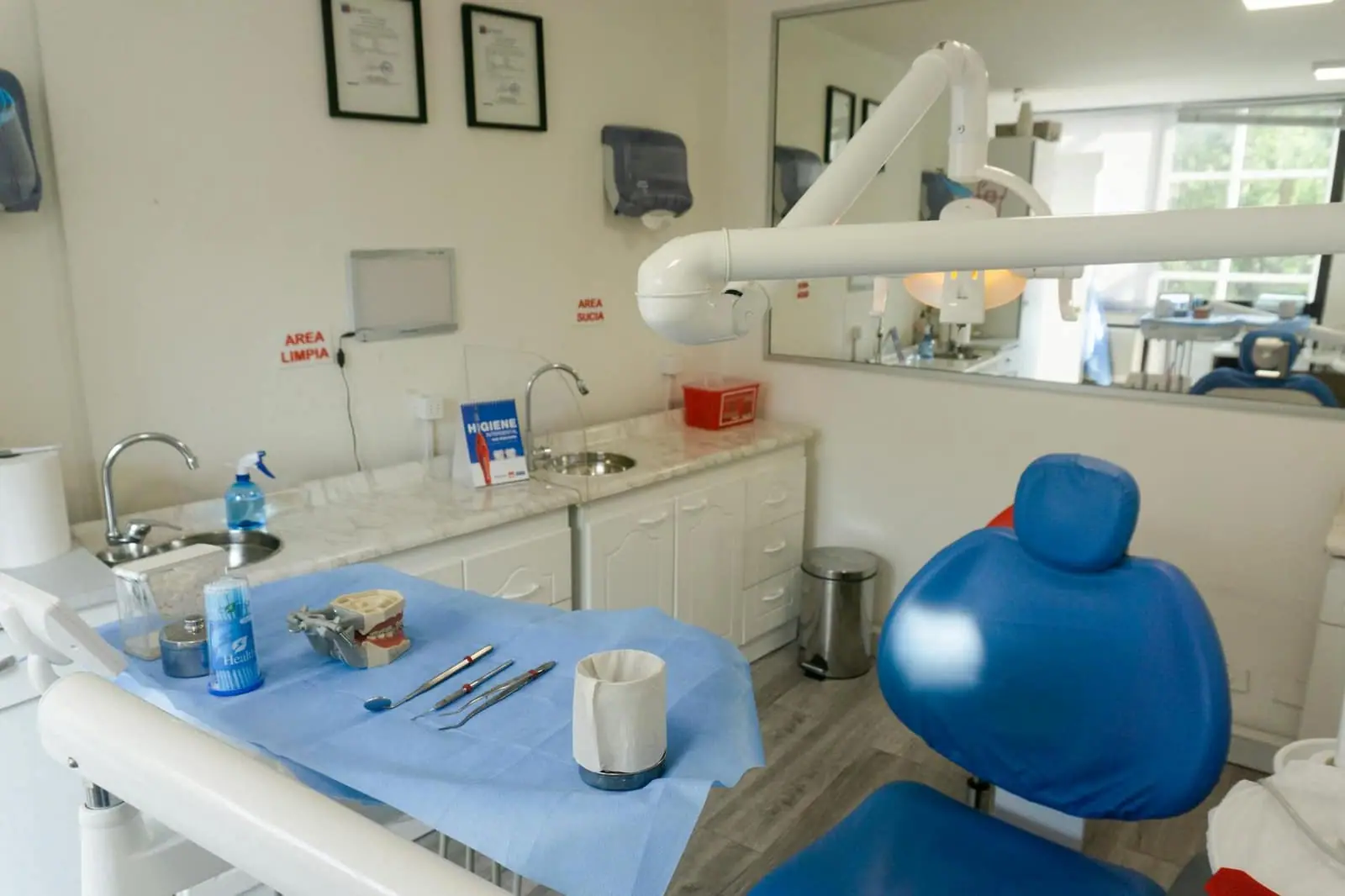Clean and organized dental examination room with equipment and instruments ready for patient care.