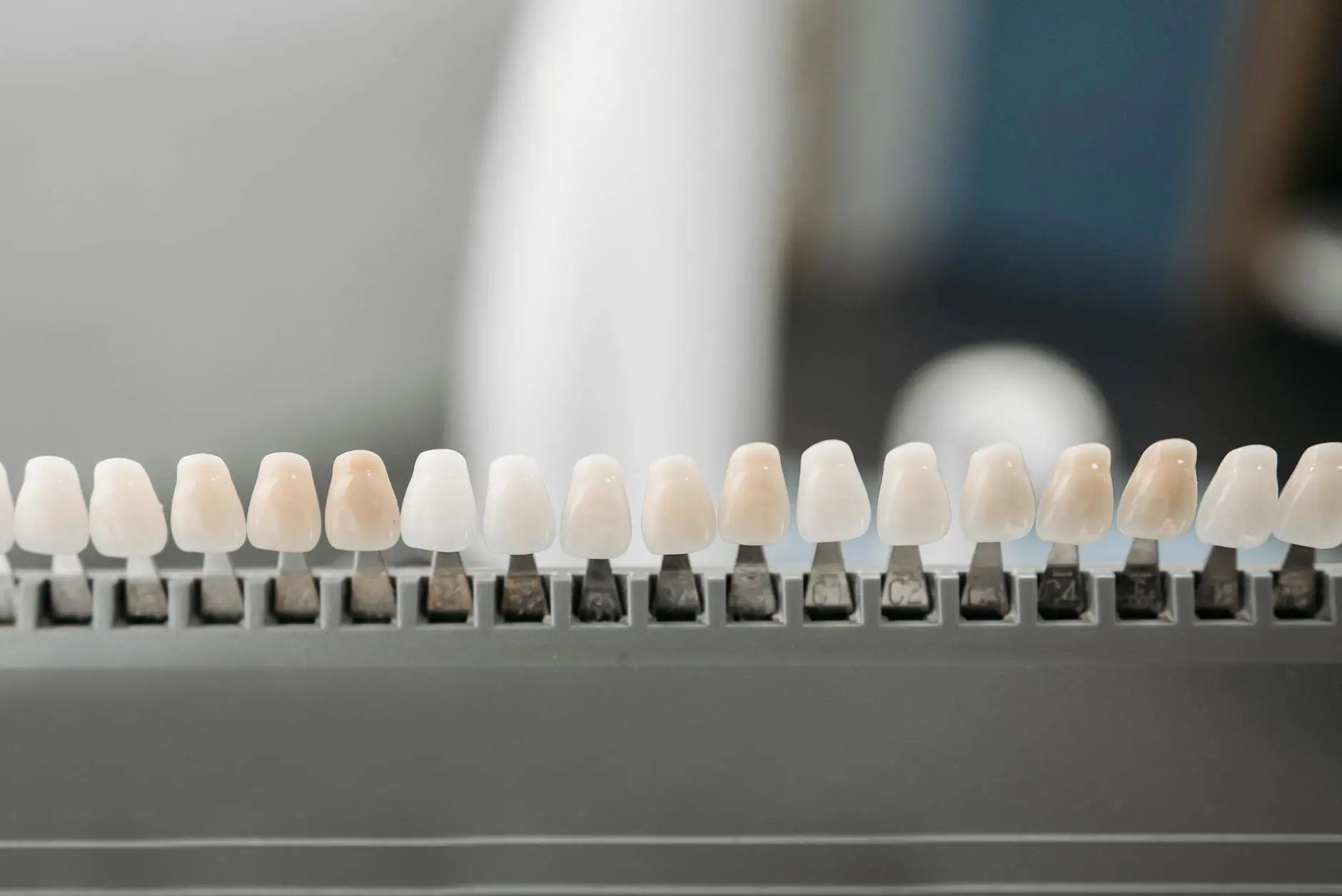 Close-up of dental veneers arranged neatly on a display rack in a dental office setting.
