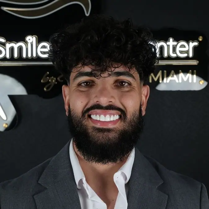 Patient at the Smile Dental Center Miami sign